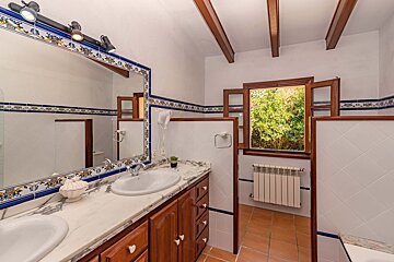 A bathroom with two sinks and a window