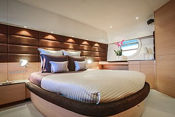 A bedroom with a round bed and a window