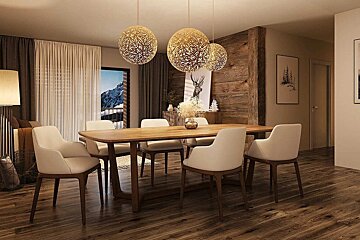 A cozy alpine dining room with a wooden table, white chairs, and three ornate spherical pendant lights.