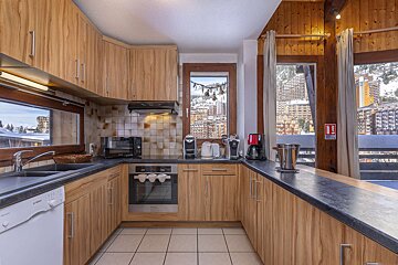A kitchen with a fire extinguisher on the counter