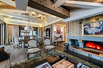 A living room with a fireplace and a painting on the wall