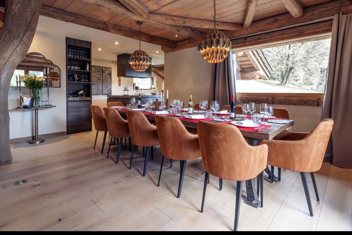 A dining room with a large table and chairs