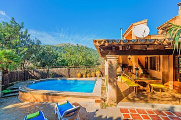 A house with a swimming pool and a satellite dish on the roof