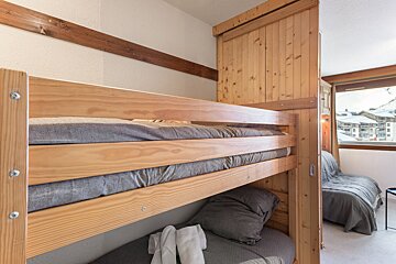 A bunk bed with a couch underneath it