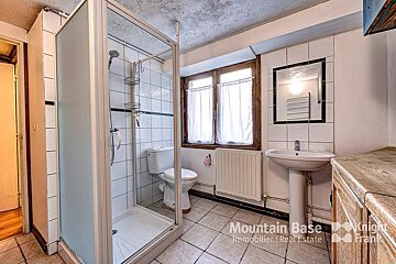 A bathroom with a toilet and a sink from mountain base