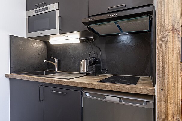 A ski lift is going up a snowy mountain