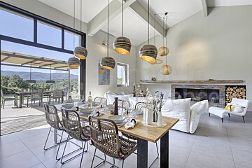 A dining room with a table and chairs and a fireplace