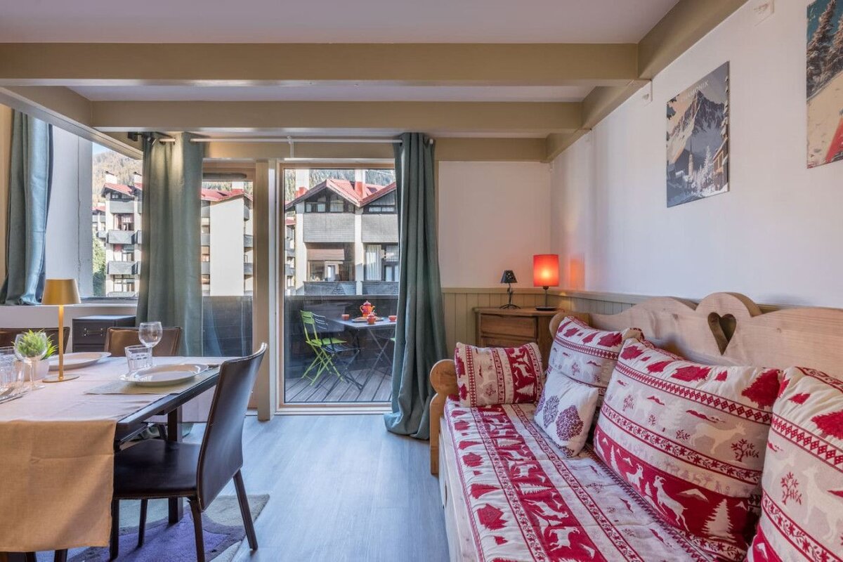 A living room with a couch and a table and chairs