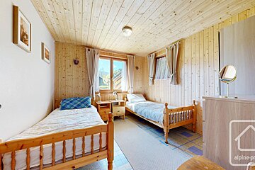 A bedroom with two beds and a sign that says alpine-pro