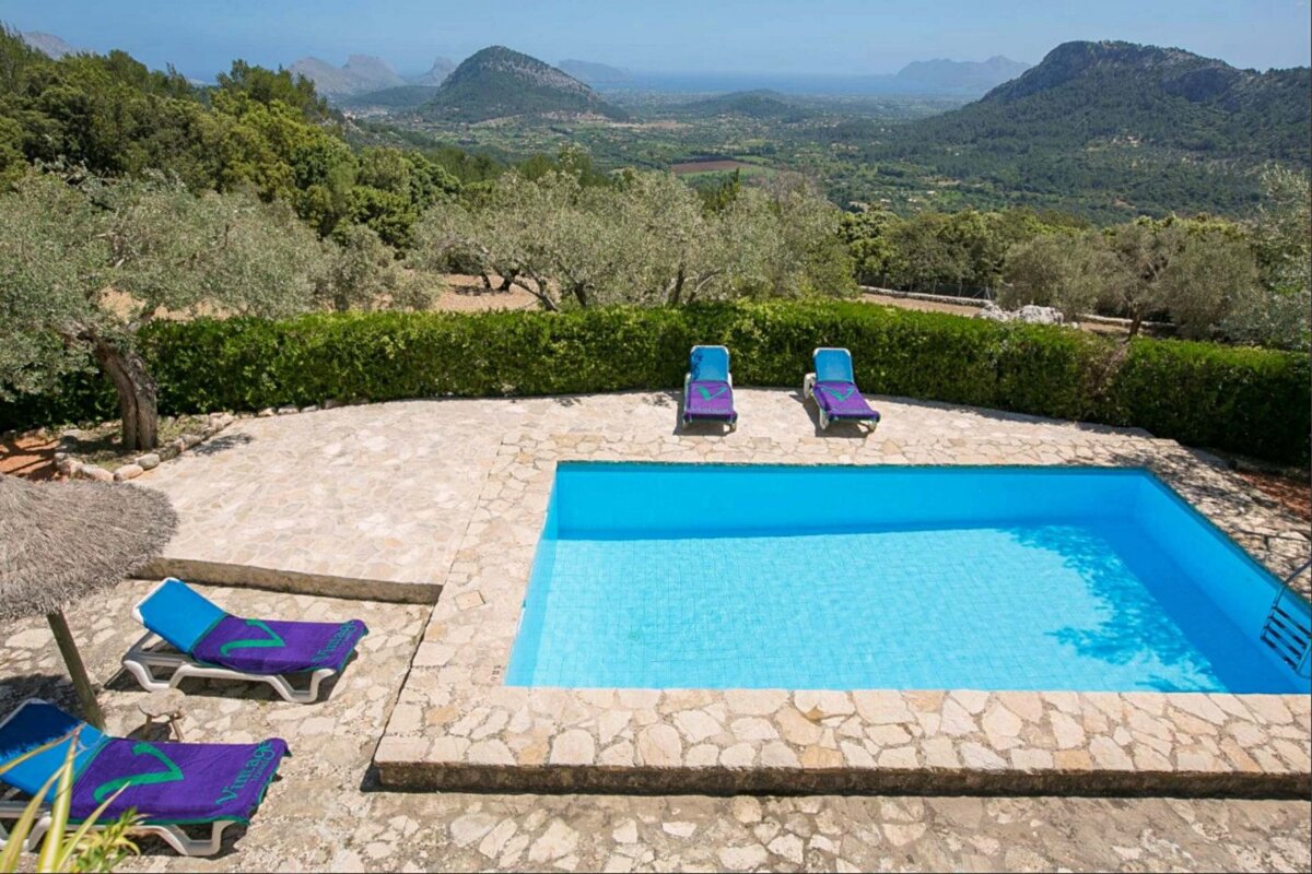 A swimming pool with a view of the mountains in the background