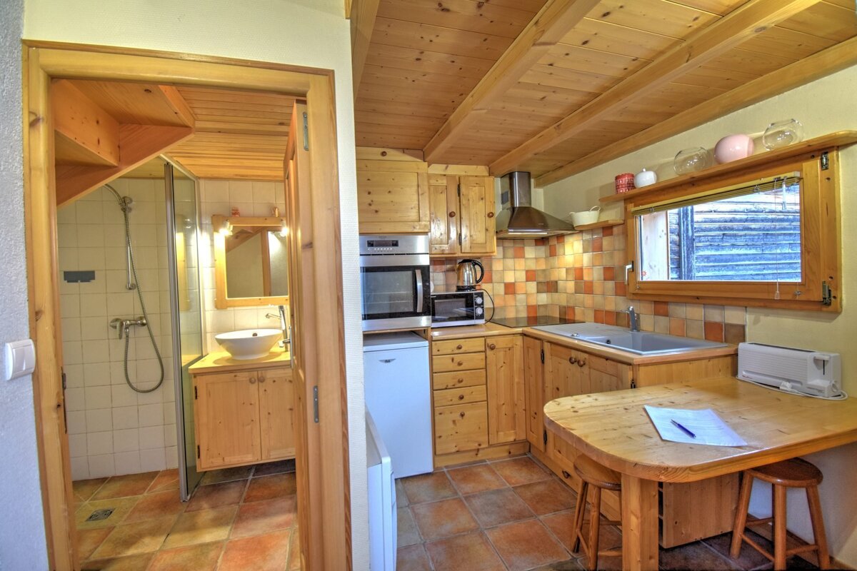 A kitchen with wooden cabinets and a white refrigerator