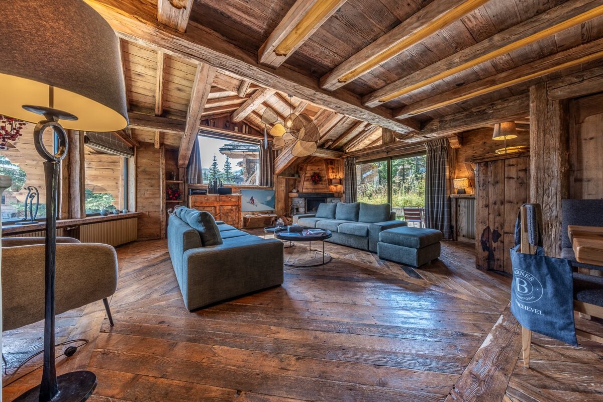 A living room with a couch and chairs and a bag with the letter b on it