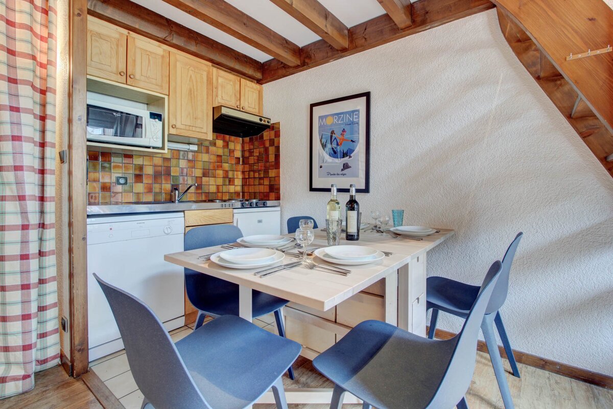 A kitchen with a picture on the wall that says morzine