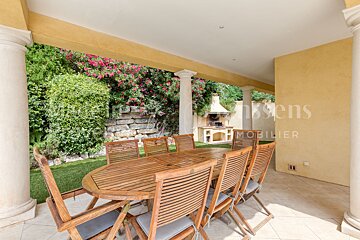 A table and chairs on a patio with a sign that says mobilier