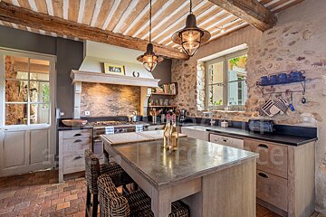 A kitchen with a bottle of wine on the counter
