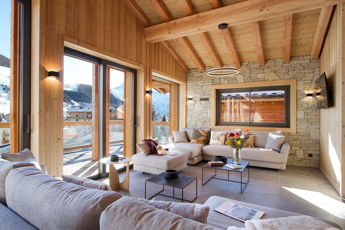 A living room with a lot of windows and a couch