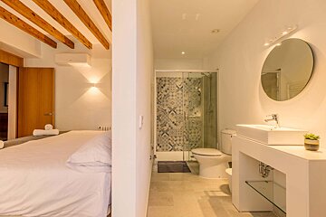 A bathroom with a toilet a sink and a mirror
