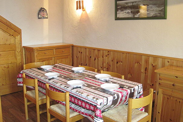 A dining room table with plates and bowls on it