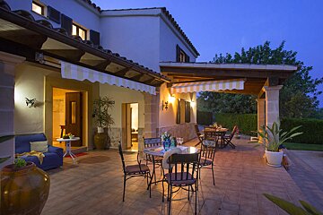 A patio with a table and chairs under an awning