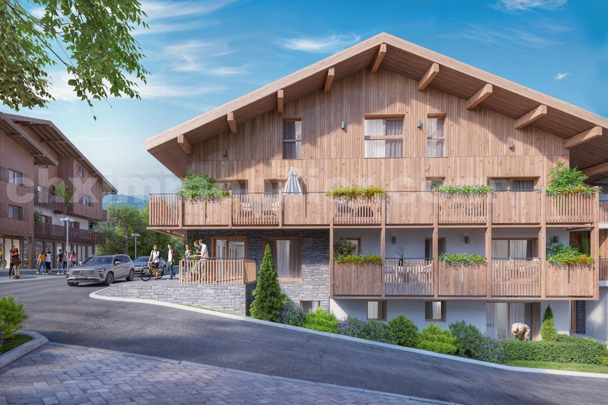 Large wooden chalet-style buildings with balconies overlook a street bustling with people, cars, and bikes on a sunny hillside.