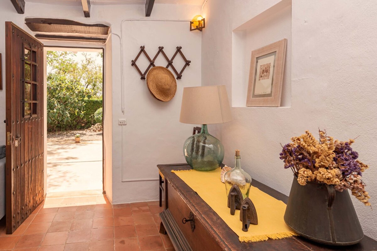 A table with a yellow table cloth and a lamp on it