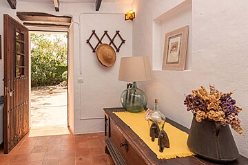 A table with a yellow table cloth and a lamp on it