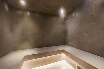 A dark room with a few lights on the ceiling