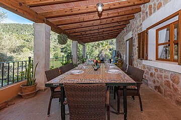 A long table with a bottle of wine on it