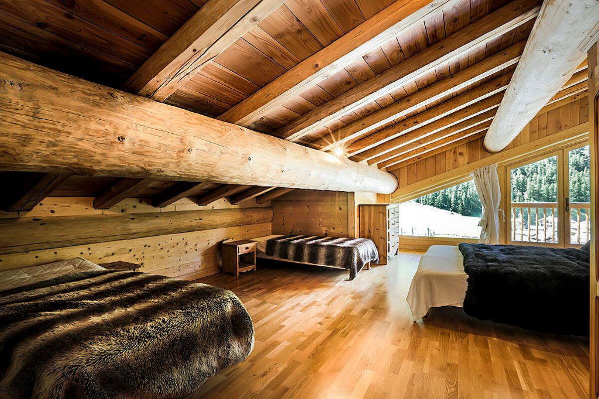 A bedroom with two beds and a fur blanket