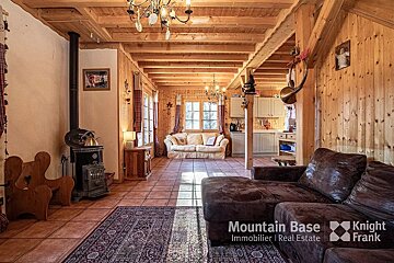 A living room with a couch that says mountain base on it