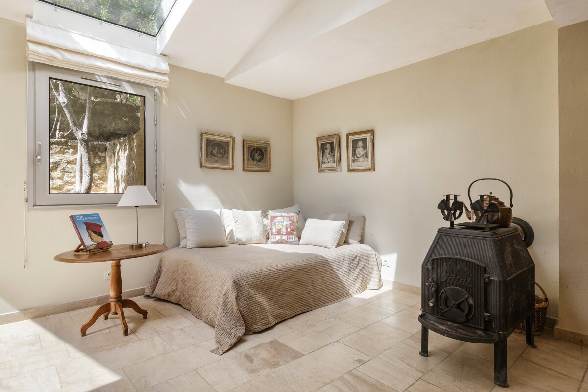 A room with a bed and a stove that says ' stihl ' on it