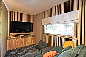 A living room with a couch and a flat screen tv