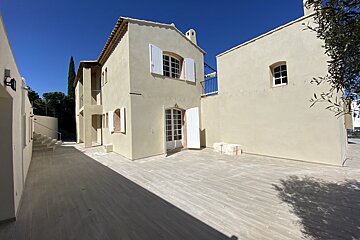 A white building with a staircase leading up to it