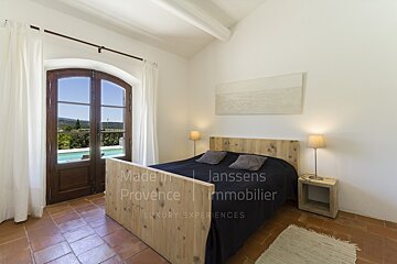 A bedroom with a bed made by janssens immobilier