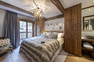 A bedroom with a large bed and a chair that says ' i love you ' on it