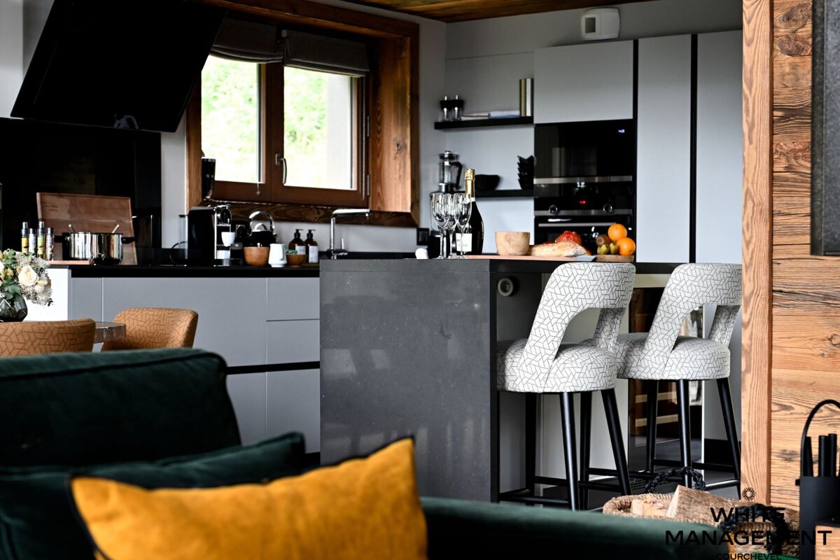 A kitchen with a rental designer logo in the corner