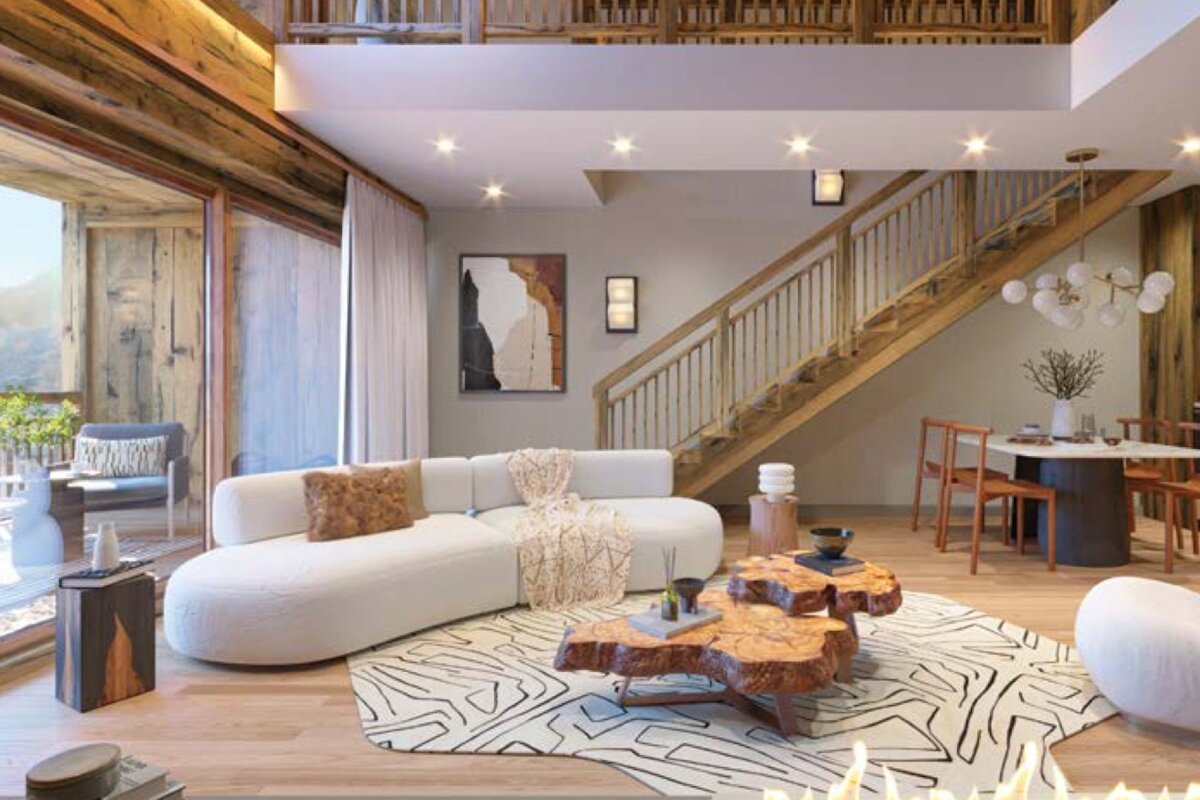 Modern rustic living room featuring a curved white sofa, live-edge wood coffee tables, a patterned rug, and a wooden staircase.