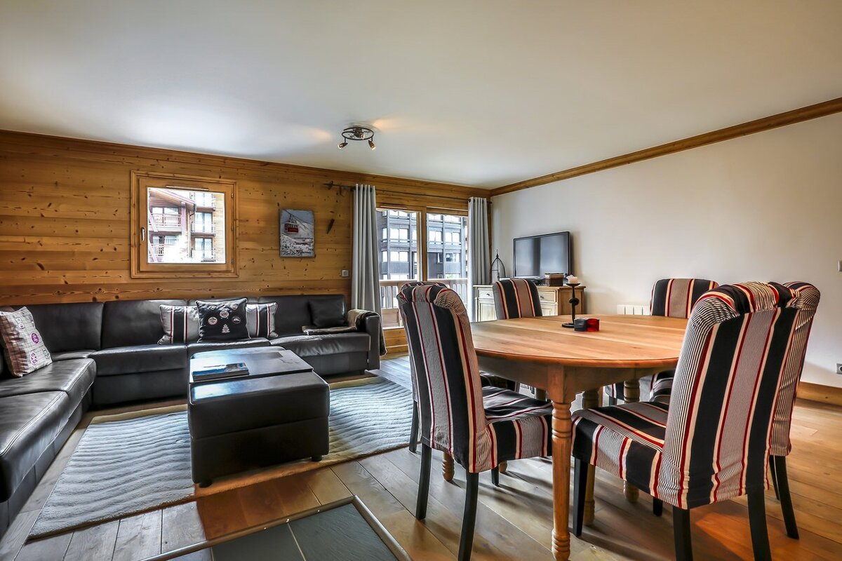 A living room with a dining table and chairs