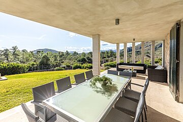 A patio with a table and chairs and a couch