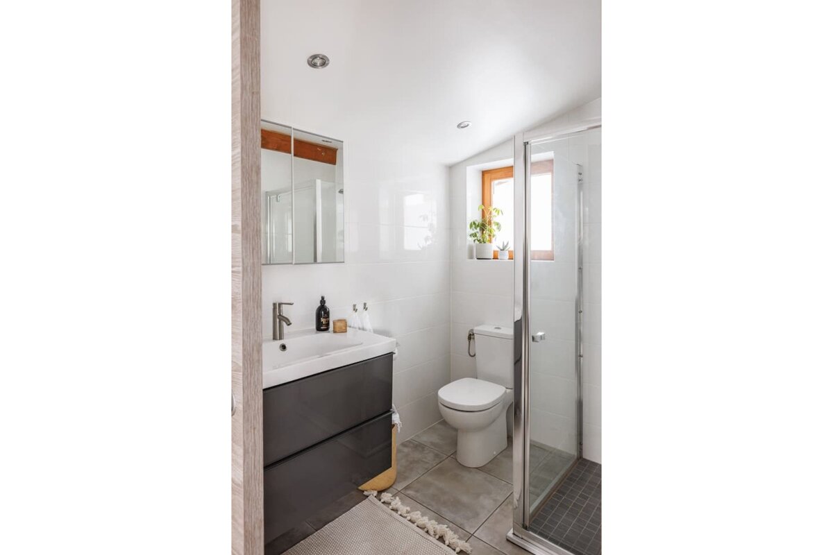 A bathroom with a toilet a sink and a shower