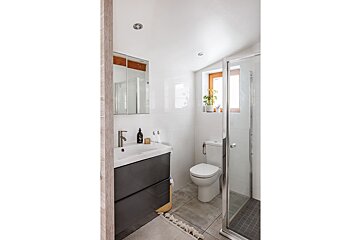 A bathroom with a toilet a sink and a shower