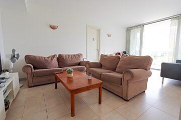 A living room with a couch and two chairs