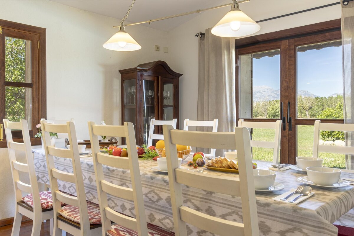 A dining room table with plates of food on it