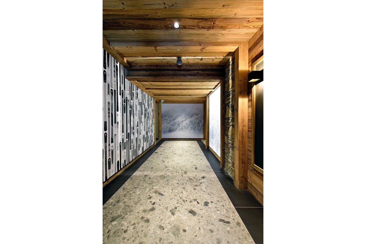 A hallway with a picture of a snowy mountain on the wall