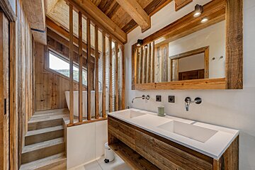 A bathroom with two sinks and a large mirror