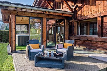 A wooden house with a hot tub in the backyard