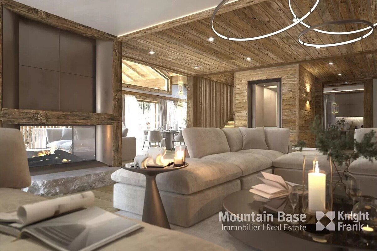An elegant, modern chalet living room features a roaring fireplace, warm wooden accents, plush beige sofas, and contemporary ring lights, creating a cozy ambiance.