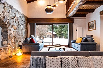 A living room with two couches and a sliding glass door