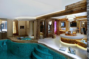 A bathroom with a swimming pool and a chandelier