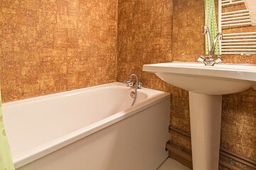 A bathroom with a bathtub and a sink